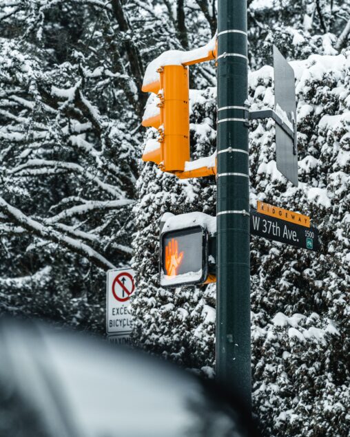 Traffic Light and Street Sign covered by snow
